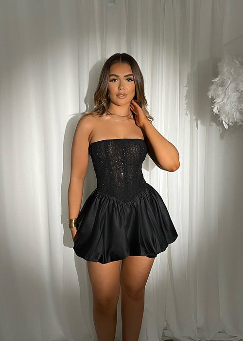 Women's black strapless mini dress with embellished details. Skater style mini dress.